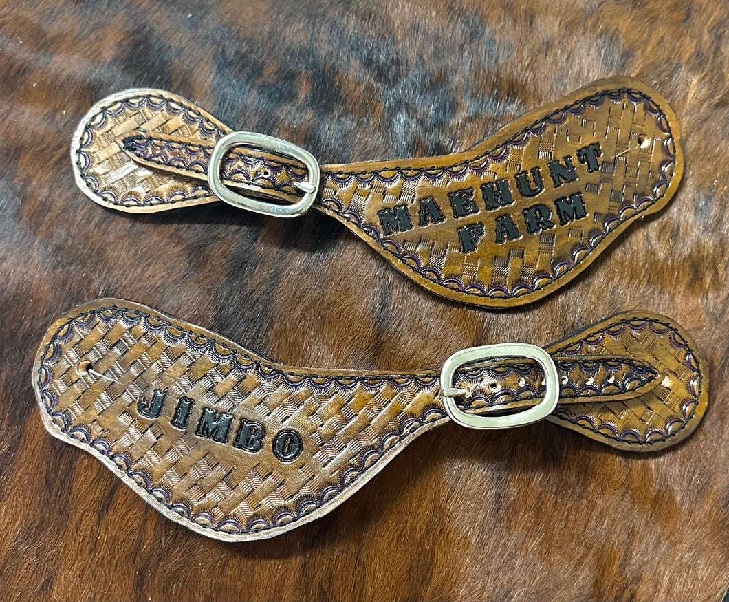 Hand tooled and painted basket weave spur straps.