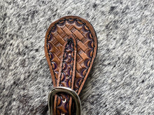 Hand tooled and painted basket weave spur straps.