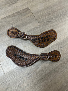 Hand tooled and painted basket weave spur straps.