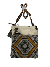 myra yellow and black cowhide canvas cross body  bag with tooled leather