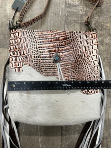 cowhide hand bag with leather strap and fringe